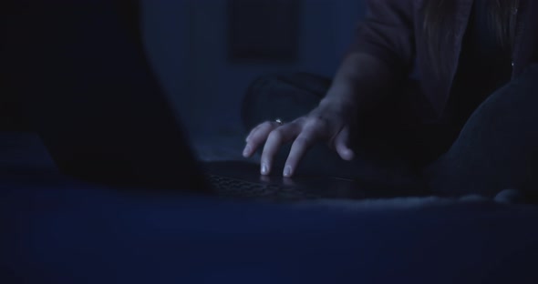 Woman scrolling a touchpad on the laptop