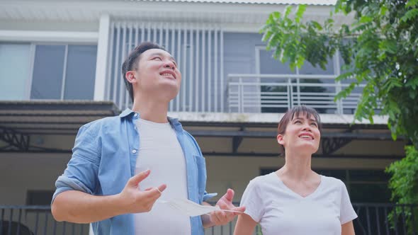 Asian young couple take deep breathing after removing protective face mask after quarantine.