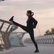 Sportswoman Warming Up Near Railing on Embankment - VideoHive Item for Sale