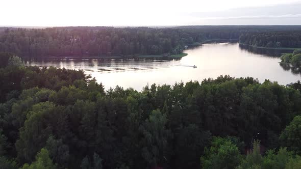 Drone flying over lake and forest