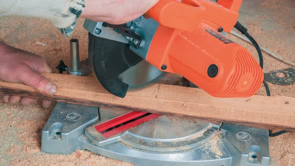 Carpenter Using Circular Saw for Cutting Wooden Boards