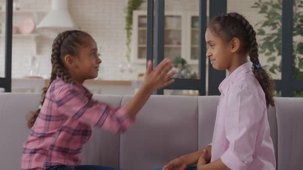 Carefree African Sisters Playing Staring Contest