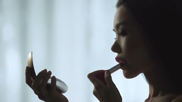 Charming Girl Carefully Putting on Red Lipstick, Slowly Painting Beautiful Lips