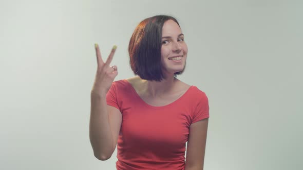 Young woman showing peace sign