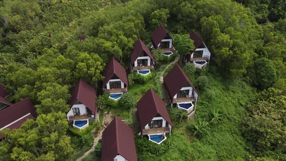 Aerial view of beautiful isolated villa with small swimming pool in the middle of a forest