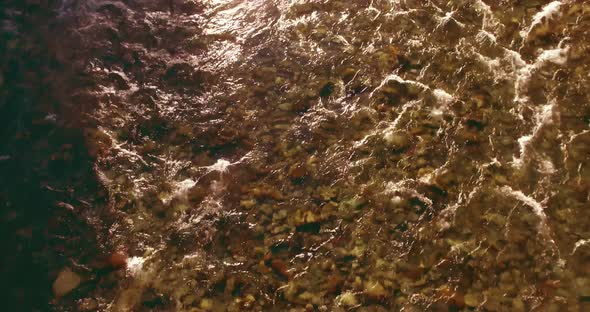 Low Altitude Flight Over Fresh Fast Mountain River with Rocks at Sunny Summer Morning