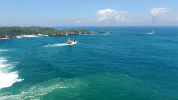 Turquoise Indian Ocean crash on rocks by Asmara Beach, Java, Indonesia, aerial