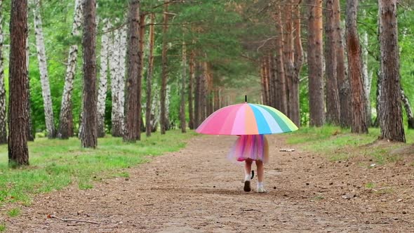 Happy Funny Girl Holding Rainbow Umbrella