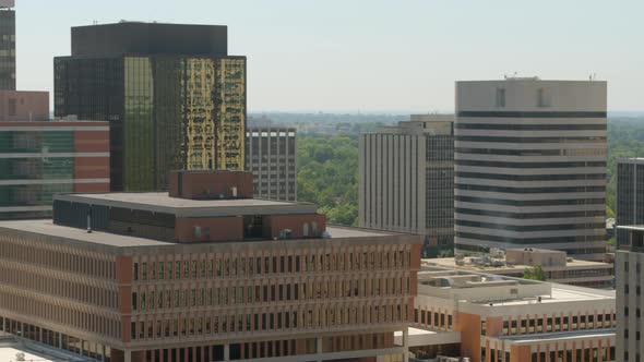 Aerial midlevel view of downtown city with a pan showing skyline.