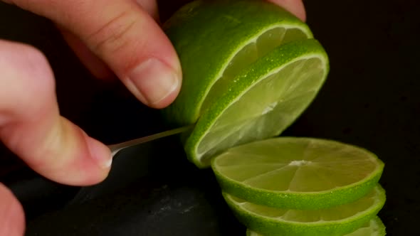 Cutting lime close up 4K black background