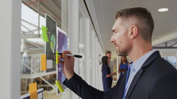 Businessman writing notes at a business conference