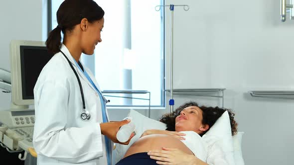 Doctor doing ultrasound scan on pregnant woman