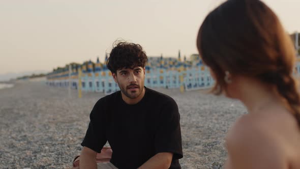 Young Couple Talking on the Sea Shore