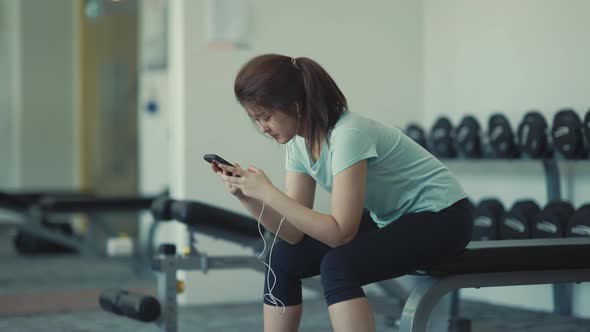 Asian cute girl She is using her cell phone to chat with her friends.