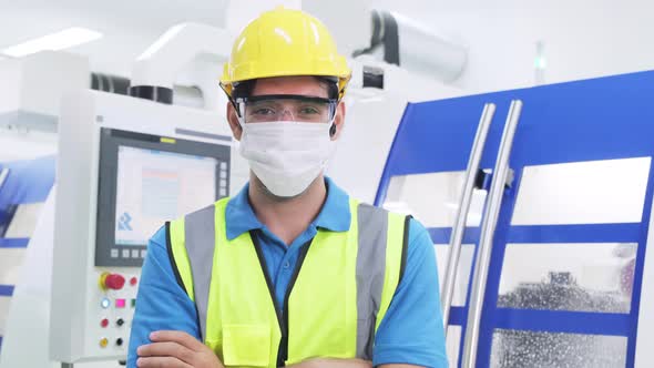 Caucasian man worker people wearing protective face mask in production factory due to covid 19.