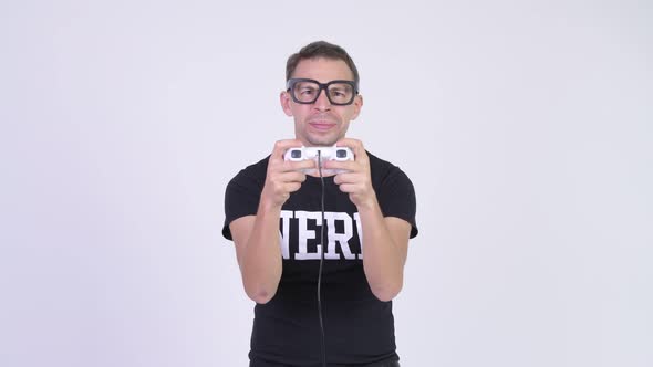 Studio Shot of Happy Nerd Man Playing Games and Winning