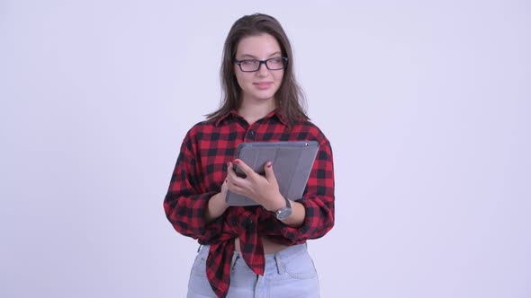 Happy Young Beautiful Hipster Woman Thinking While Using Digital Tablet