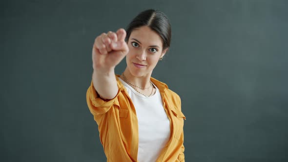 Portrait of Beautiful Lady Pointing at Camera Then Counting with Fingers From One to Five