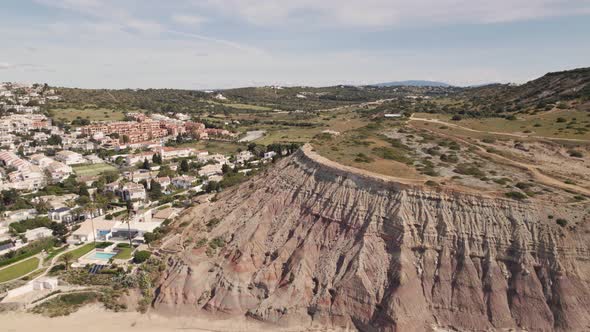 Fly-over Big cliff slope revealing Praia da Luz and Townscape, Algarve