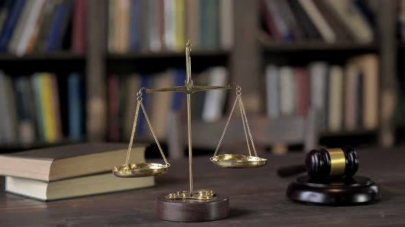 Gavel and Balance Scale on Judge Wooden Table