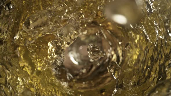 Super Slow Motion Shot of White Wine Whirling in Glass Bottle at 1000Fps