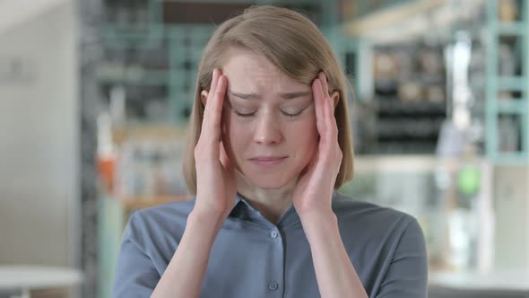 Portrait of Young Woman Having Headache