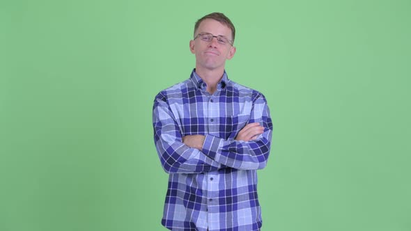 Portrait of Happy Hipster Man Smiling with Arms Crossed