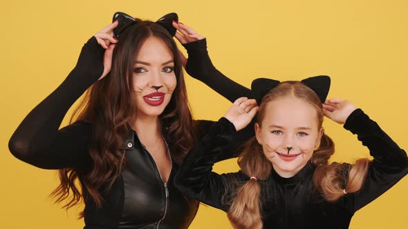 Mother and Daughter with Wearing Halloween Costumes Have in Orange Studio