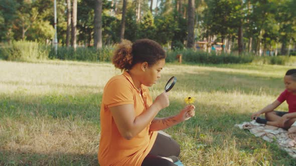 Charming Teacher Lost in Contemplation During Biology Lesson Outdoors