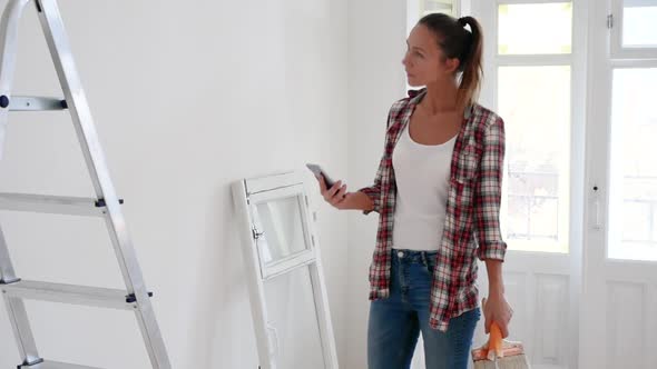 Woman Thinks, Plans, Decides About Repair Her House, Uses a Tablet or Mobile