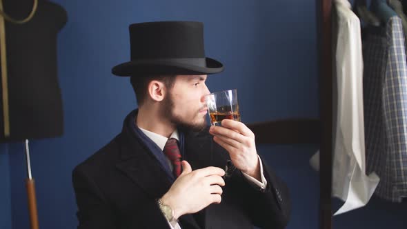 Portrait of Attractive Man in Dark Coat and Trendy Suit Indoors Tailors