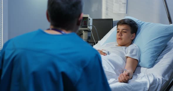 Teenager Patient Talking His Doctor in Hospital