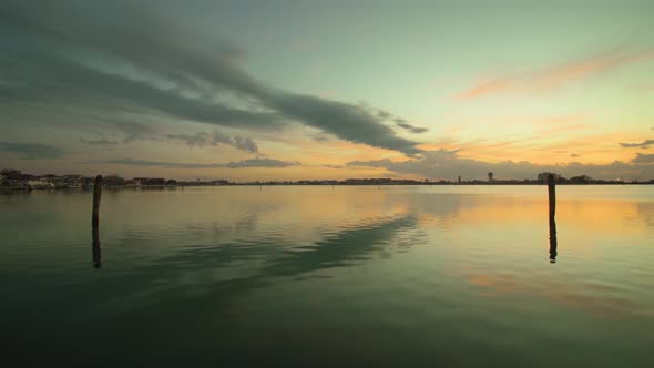 Venice Lagoon Water with Reflection of Cloudy Sky at Sunset