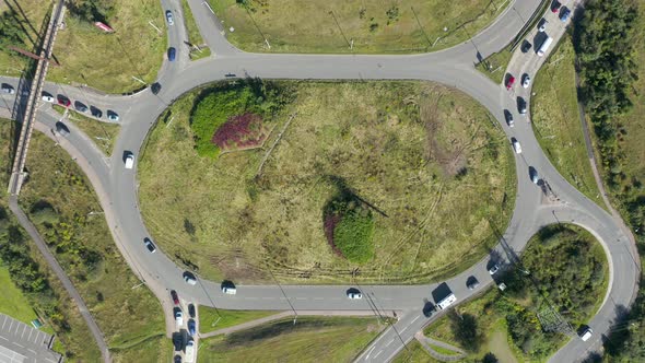 Top down aerial view of traffic using a large roundabout on a UK round