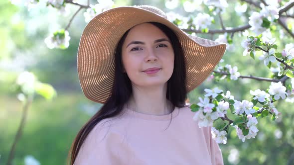 Beauty Young Woman Enjoying Apple Blooming Spring Orchard.