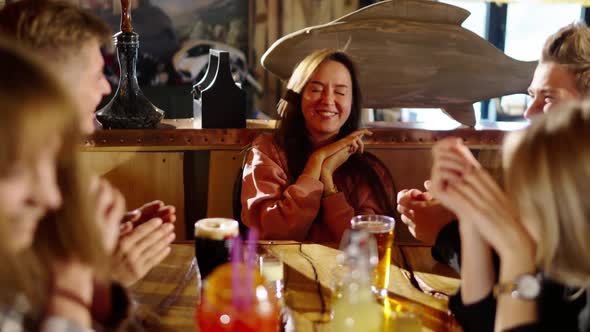 Group of Happy Multiethnic Friends Having Fun Together Drinking Bottled Beer in a Bar or at Home