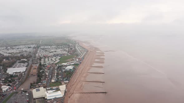 Drone shot over small english seaside beach village caravan park