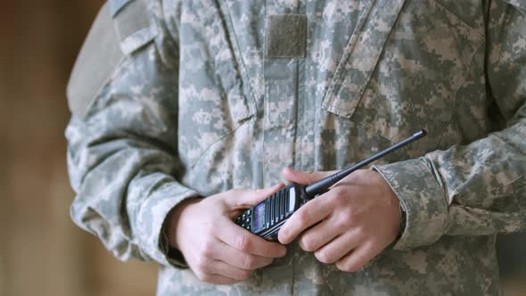 Slowmotion of Soldier Hands Military Man in Army Combat Uniform Holding Walkietalkie