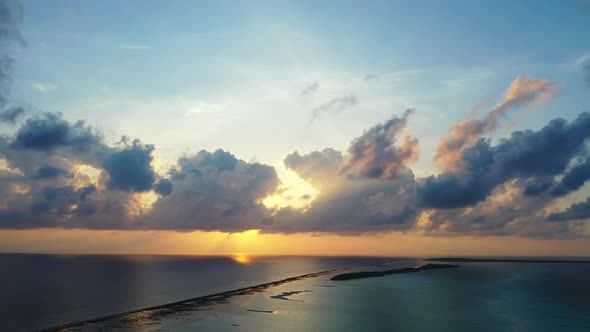 Luxury flying travel shot of a white sandy paradise beach and aqua turquoise water background 