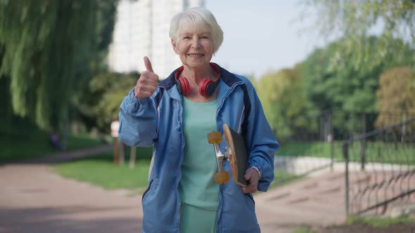 Medium Shot of Smiling Fit Senior Sportswoman Gesturing Thumb Up in Slow Motion Smiling Looking at