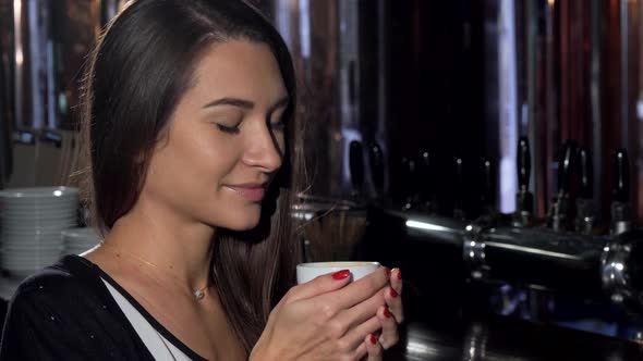 Beautiful Young Woman Smiling, Looking Away Dreamily, Enjoying Her Coffee