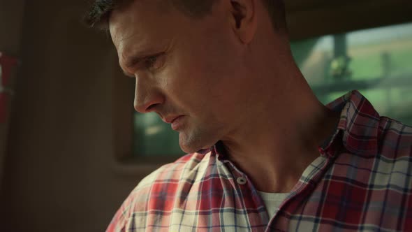 Tractor Driver Checking Harvester Inside Cabin Closeup