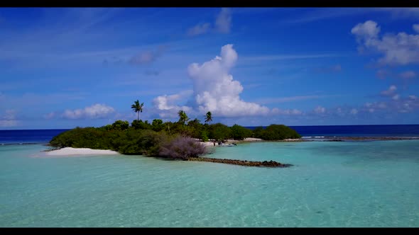 Aerial top down landscape of exotic tourist beach lifestyle by transparent water with clean sand bac