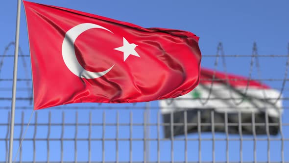 Waving Flags of Turkey and Syria Separated By Barbed Wire