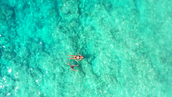 Ladies best friends on tropical resort beach holiday by turquoise ocean with white sand background o