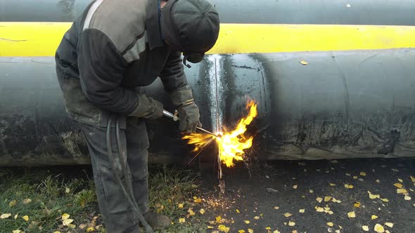 The Welder Cuts a Large Pipe with Acetylene Welding for Gasification