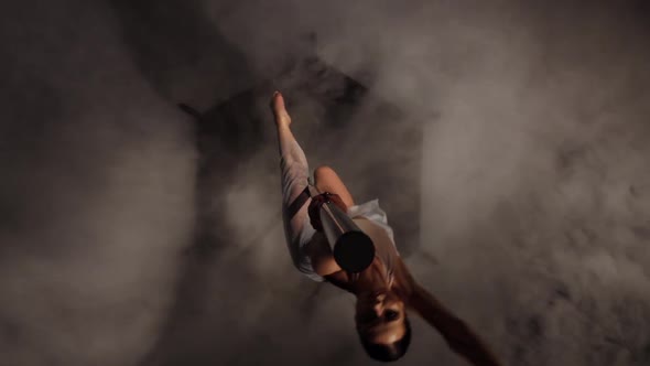 Woman Sexy Doing Pole Dance . Black Smoke Background. Top View