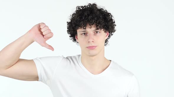 Thumbs Down by Young Man with Curly Hairs, white Background