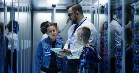 IT Technician Typing in Server Park with Children