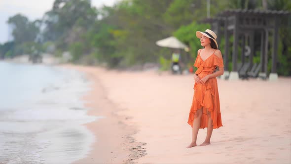 Asian woman enjoy around beautiful beach sea ocean